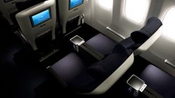 a seat and arm rest in an airplane