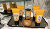 a group of bottles of cosmetics on a glass shelf