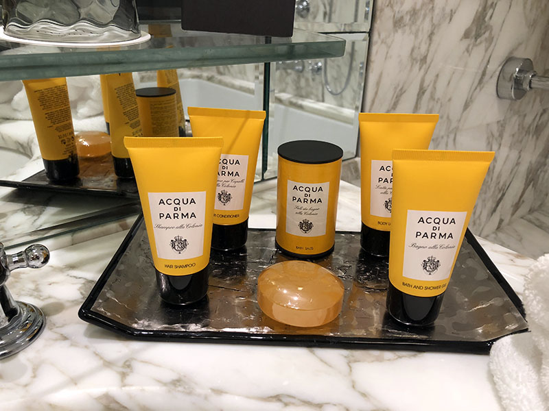 a group of bottles of cosmetics on a glass shelf
