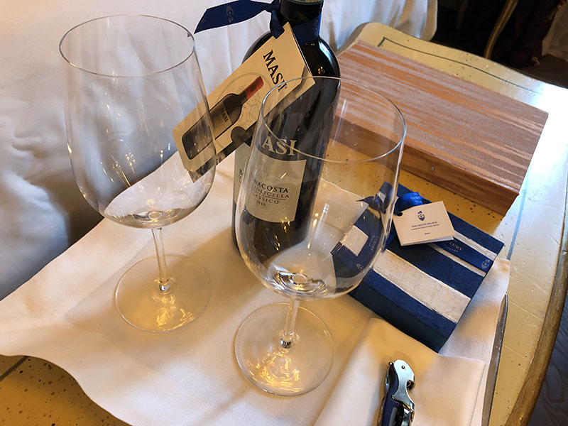 a bottle and two wine glasses on a table