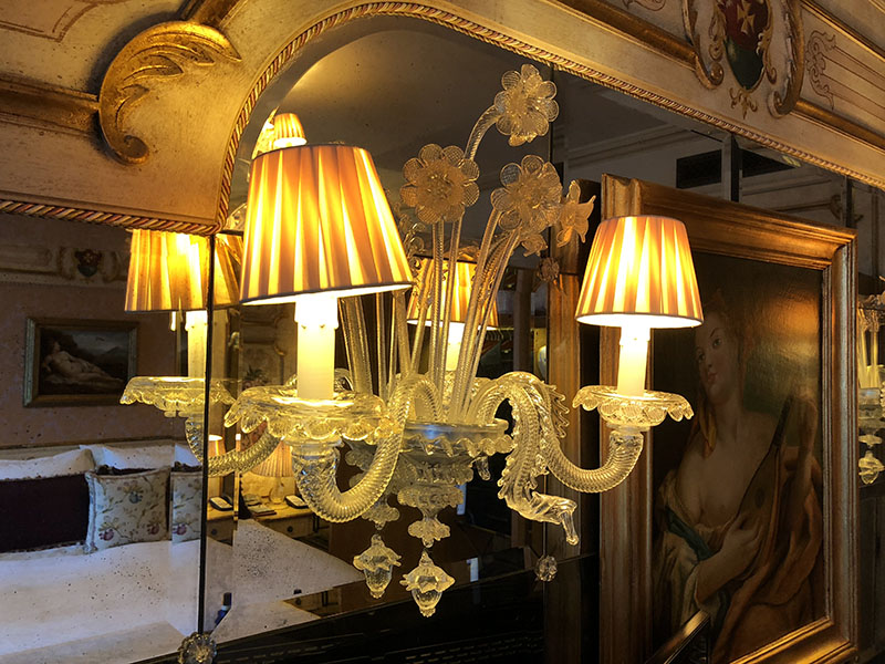 a chandelier with lamps and flowers