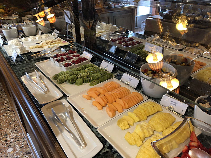 a buffet with different types of fruit on plates