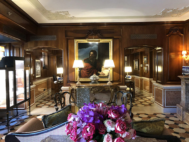 a room with a painting of a man in a painting