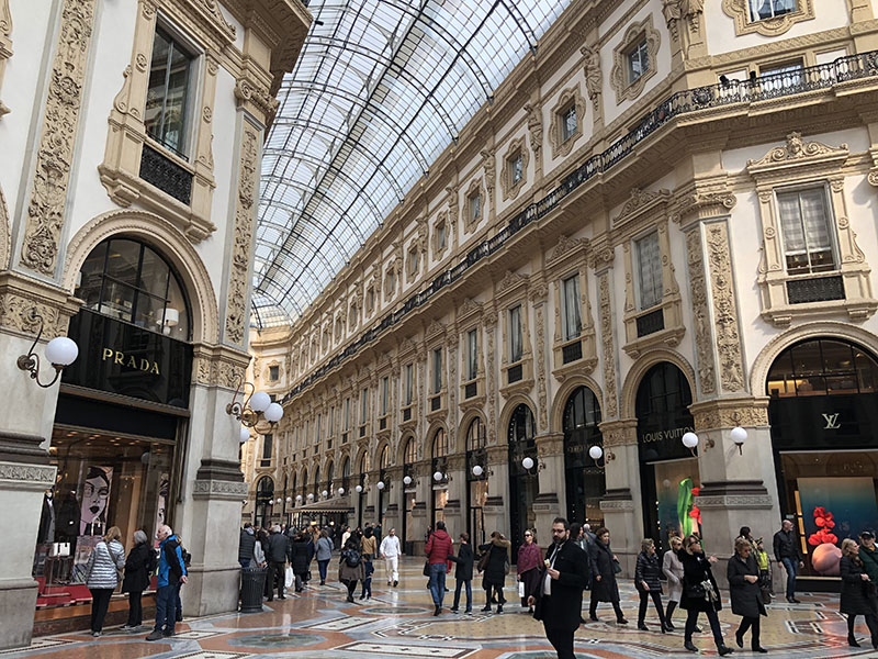 a group of people walking in a shopping mall