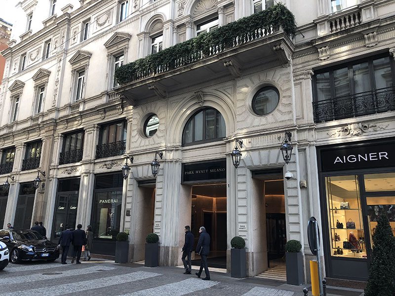 a group of people walking outside of a building