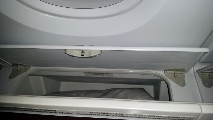 a white shelf with a pillow inside