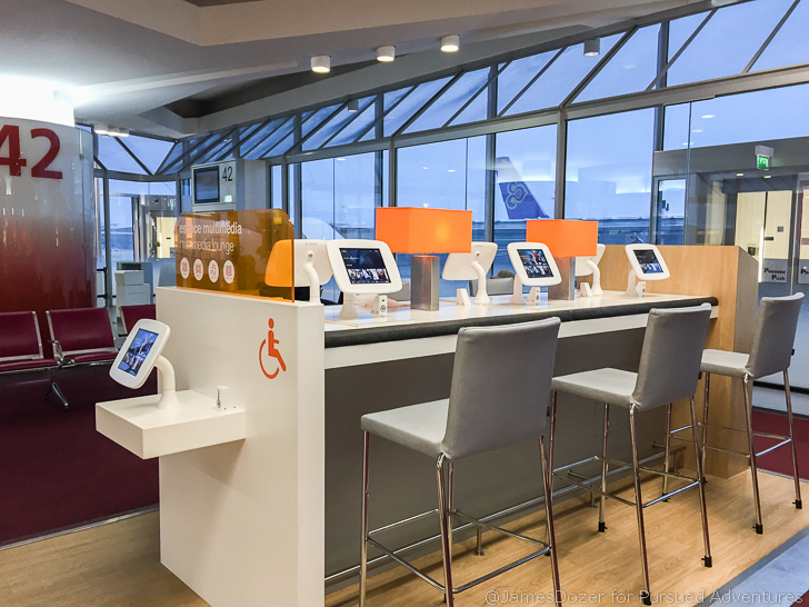 a room with a table with chairs and a table with a few tablets