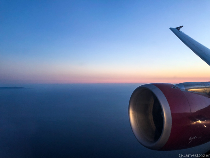 an airplane wing and a body of water