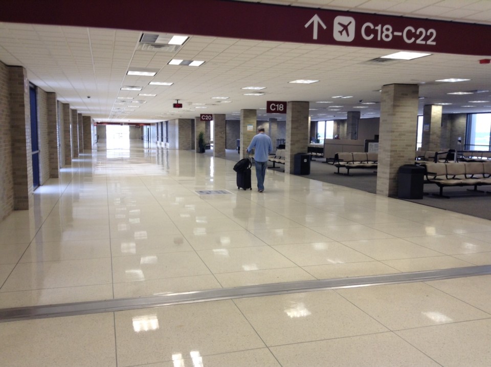 a man walking in a large white hall