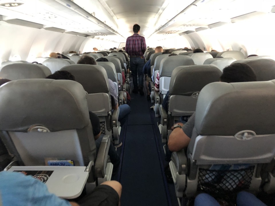 a man standing in an airplane