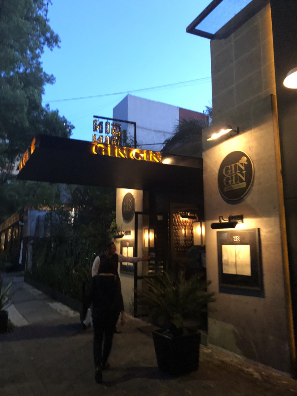 a man standing outside of a restaurant