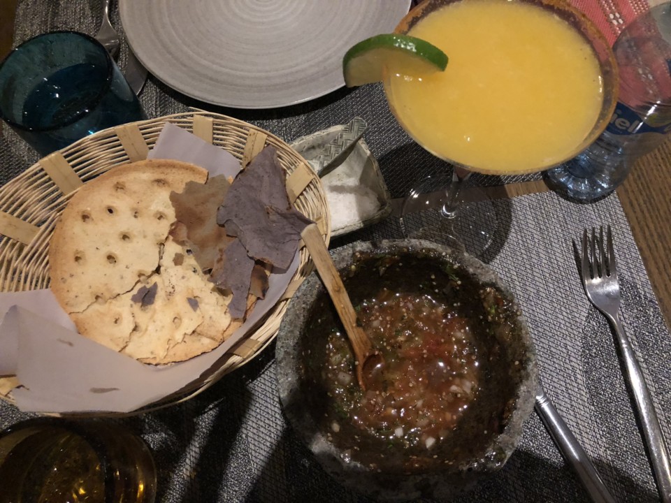 a plate of food and a bowl of salsa