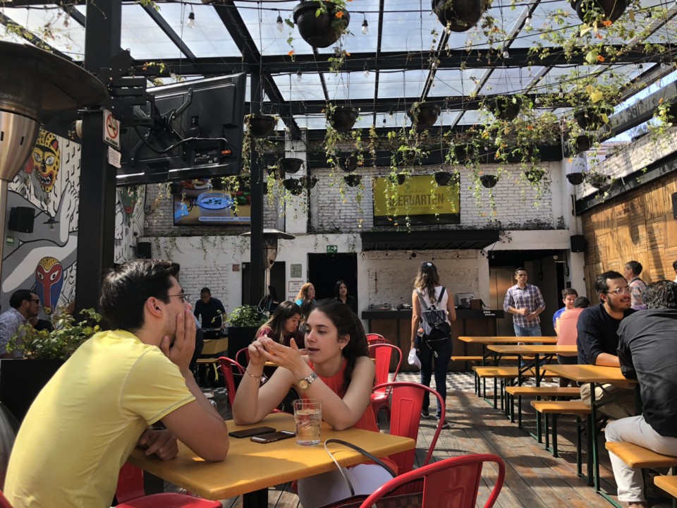 a group of people sitting at tables in a restaurant