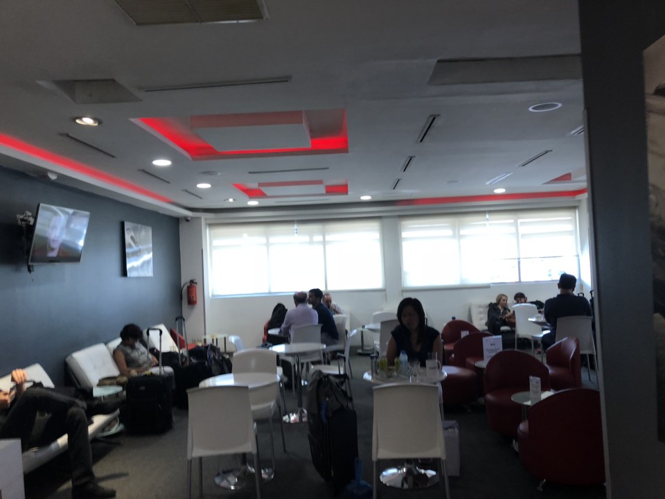 people sitting in a room with chairs and tables