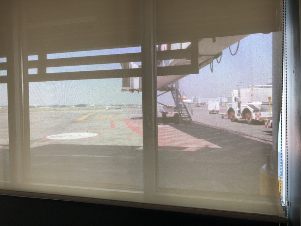 a window with a view of a plane and a plane
