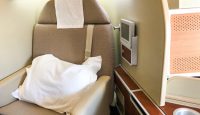 a seat with a pillow and a screen in the back