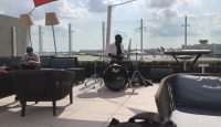 a man playing drums on a patio