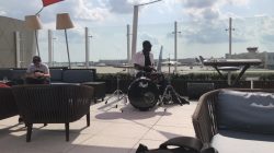 a man playing drums on a patio