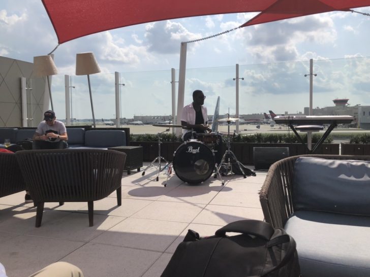 a man playing drums on a patio