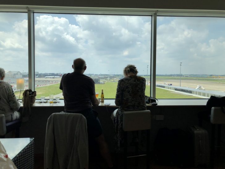 a man and woman sitting by a window
