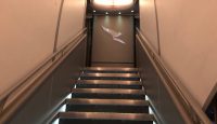 a flight of stairs with a logo on the wall