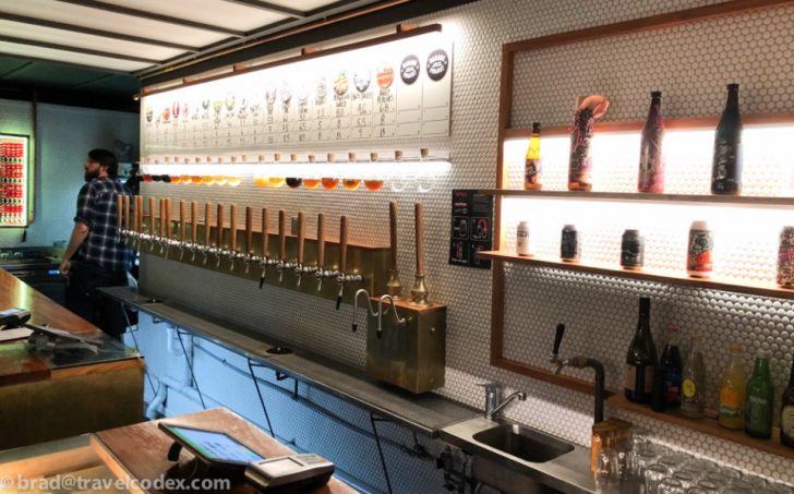 a bar with beer taps and bottles