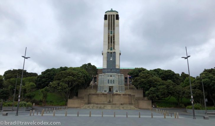 a tall tower with trees in front of it