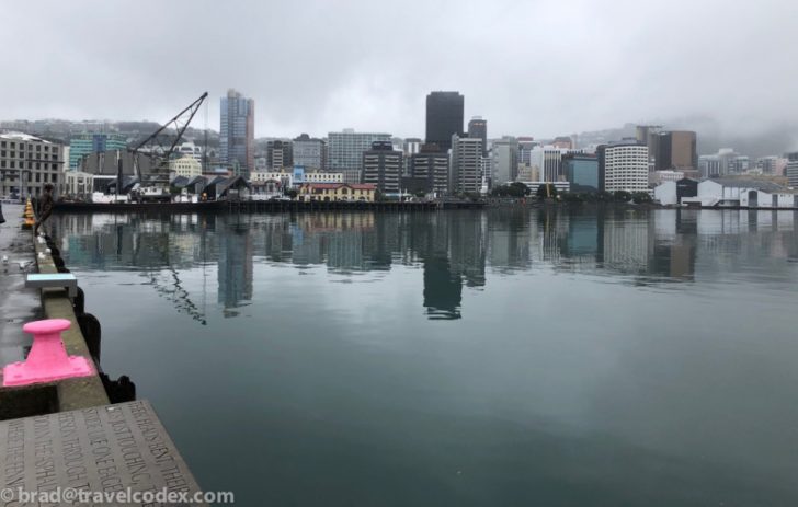 a body of water with a city in the background