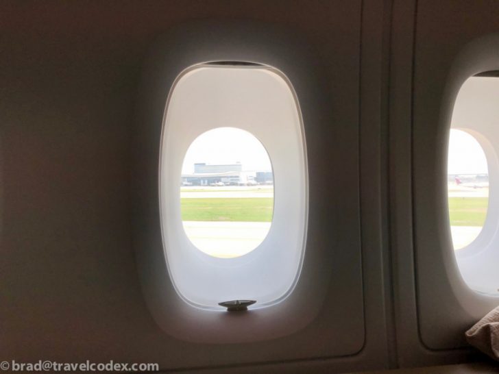 an airplane window with an oval window