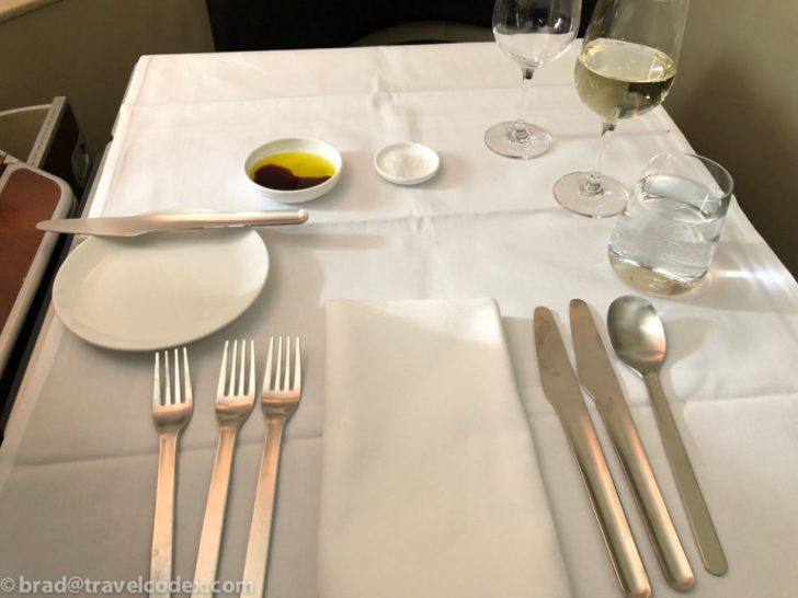 a table with a white tablecloth and silverware