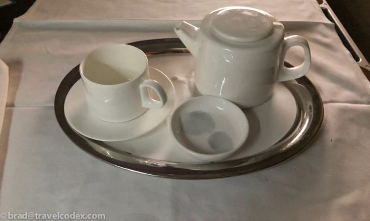 a teapot and cup on a tray