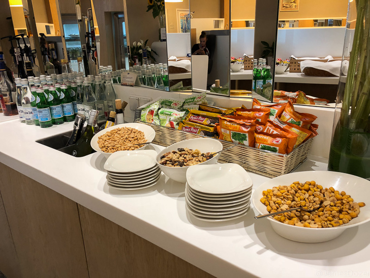 a table with bowls of food and snacks