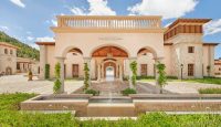 a building with a fountain and a stone walkway