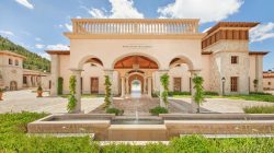 a building with a fountain and a stone walkway