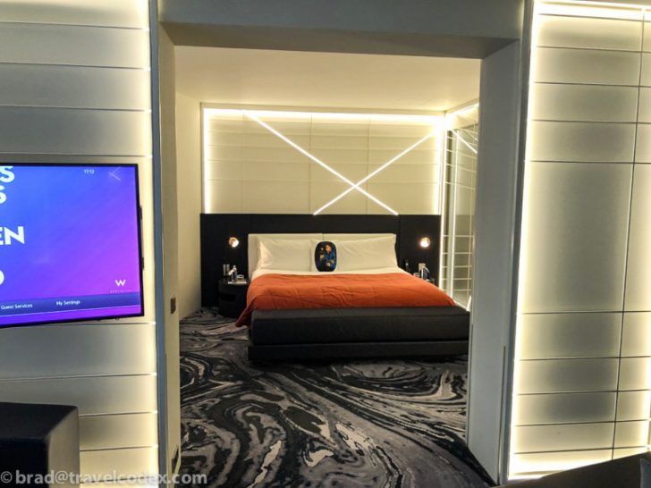 a room with a bed and a tv