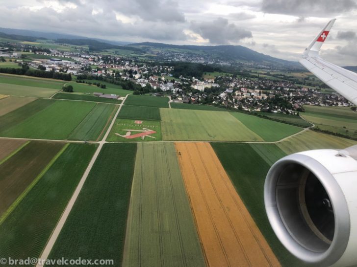 an airplane wing and a landscape