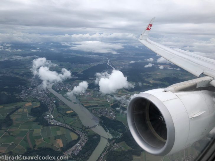 an airplane wing and engine above a river