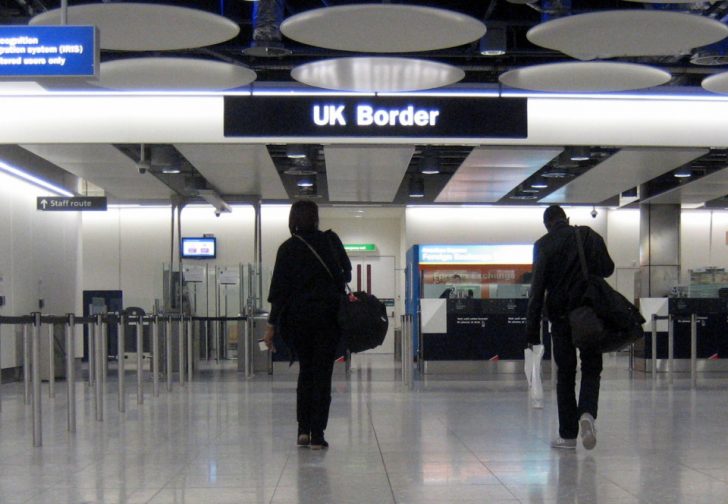 a couple of people walking in a airport