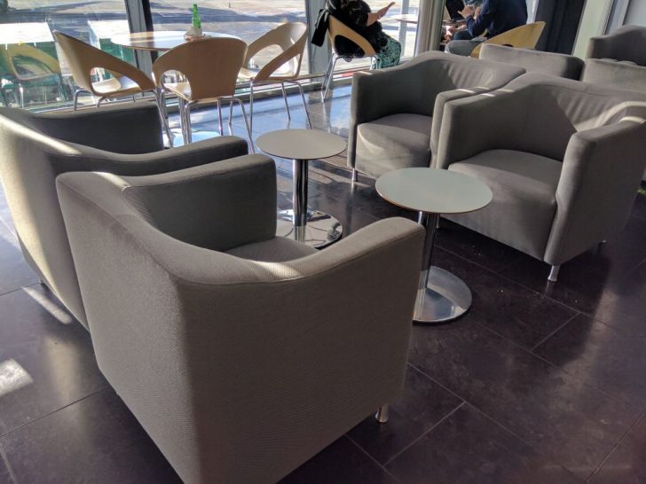 a group of chairs and tables in a room