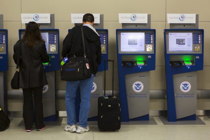 a man and woman standing next to a machine