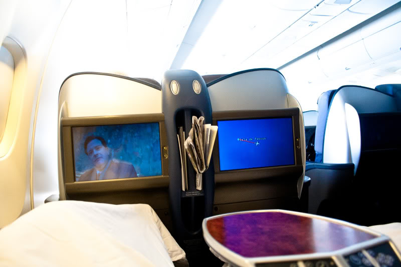 a tvs and a table in an airplane