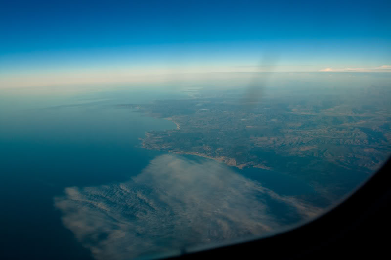 an aerial view of land and water