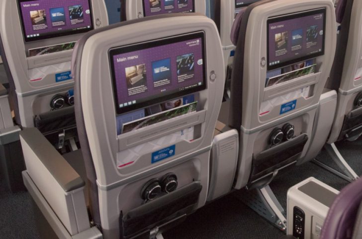 a row of seats with screens