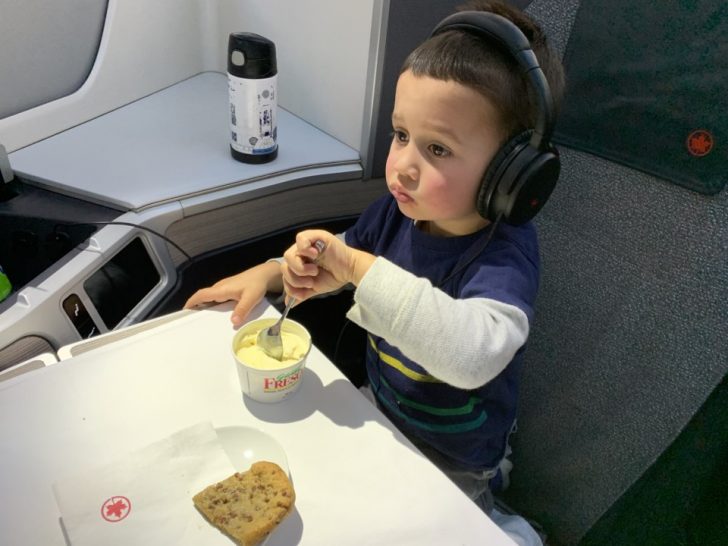 a child eating food on an airplane
