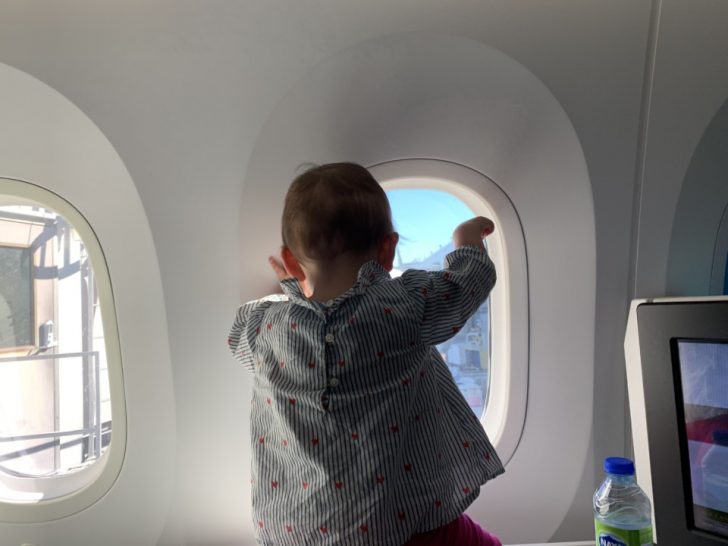 a baby looking out a window