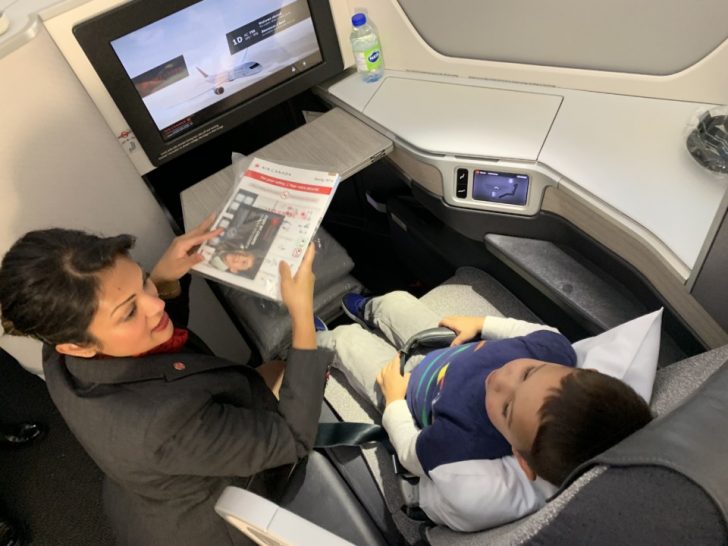 a woman and a boy sitting in a seat on an airplane