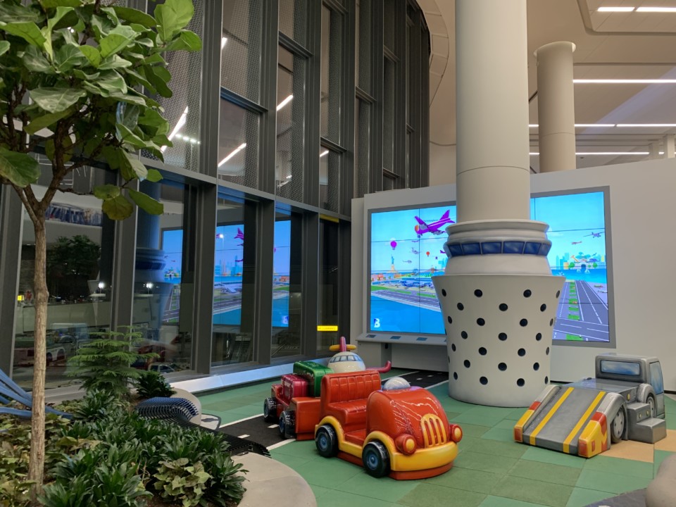 a toy car in a room with a video game screen