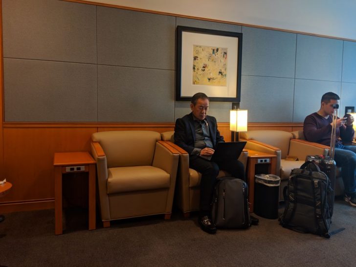 a man sitting on a couch with luggage