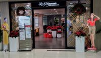 a store front with a sign and decorations