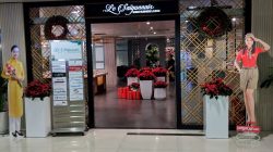a store front with a sign and decorations